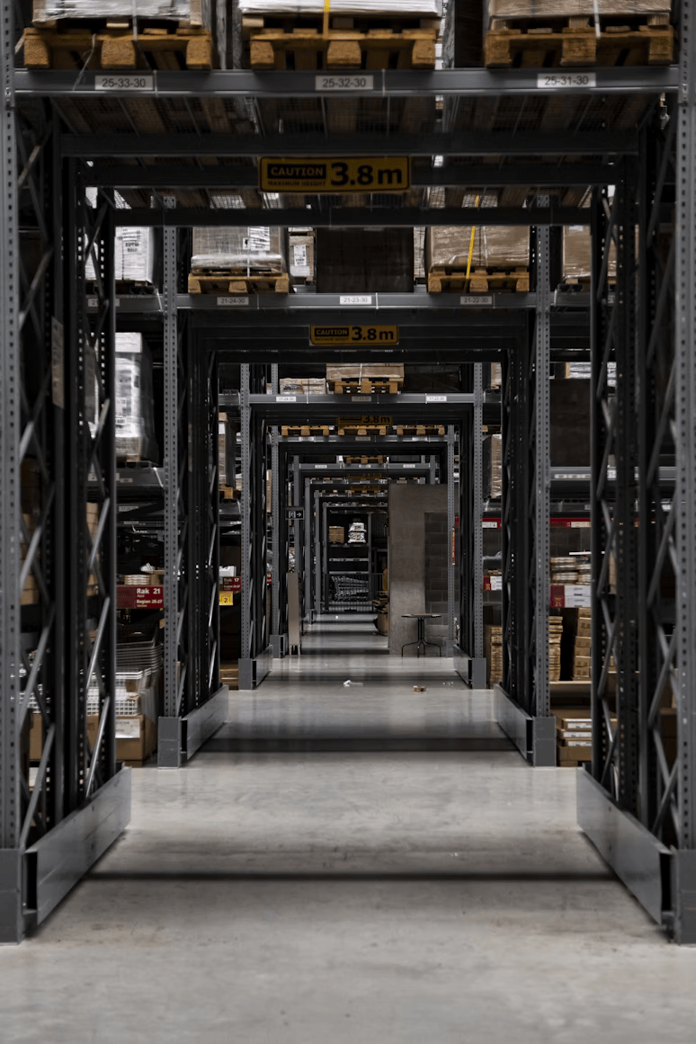 Industrial warehouse aisle with heavy-duty racking systems for auto parts distribution
